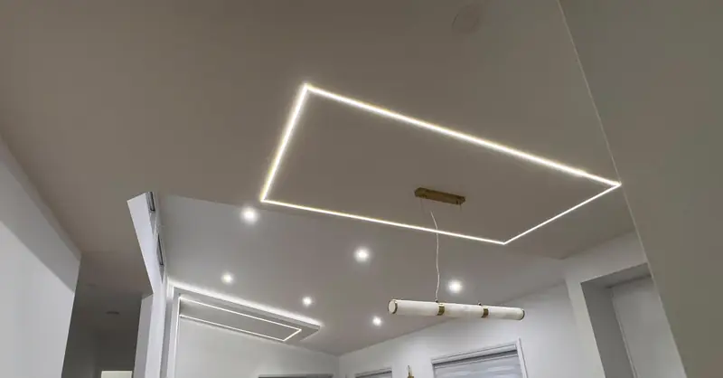 LED Linear Ceiling — Recessed linear LED rectangle over the living and dining area.