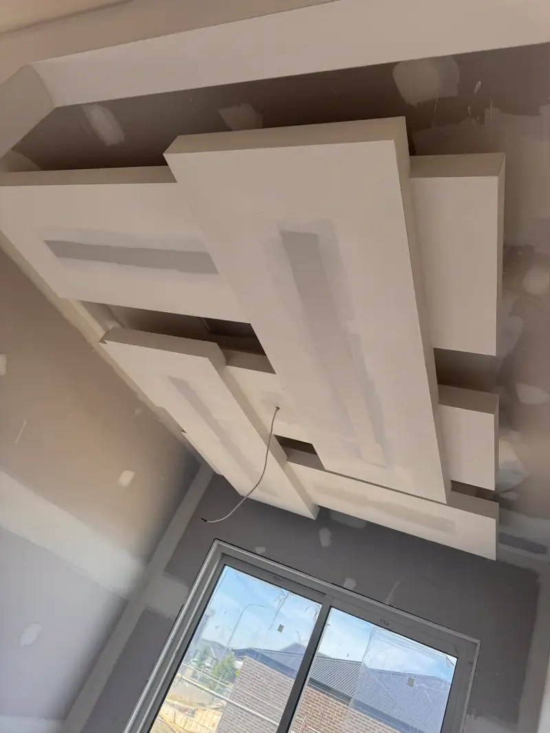 Layered ceiling panels sheeted in plasterboard