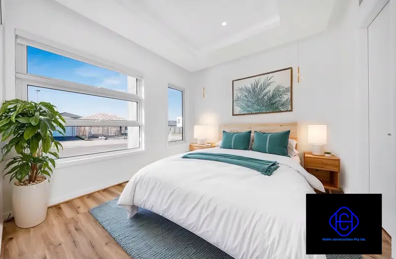 Guest Bedroom — Bedroom with a recessed ceiling detail and a large picture window.