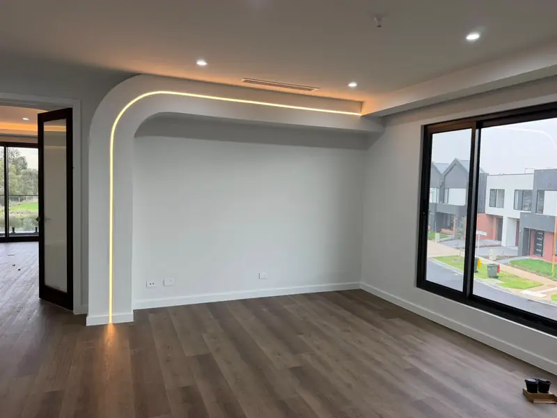Living room with an arched plaster bulkhead and LED strip lighting